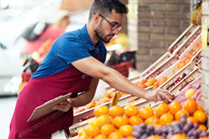 picture of a man working at a grocery store